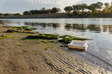 Garbage on the shore of a river 
