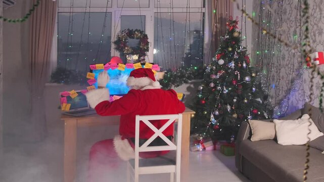 Santa organizes his tasks by attaching colorful sticky notes to the screen, coordinating holiday preparations to ensure everything runs smoothly. 