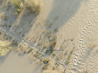 River flooding over its banks covering surrounding trees and land in Emilia Romagna, Italy