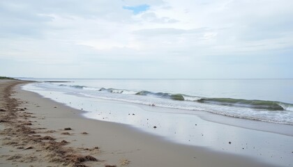  Tranquil beach scene with gentle waves and a cloudy sky