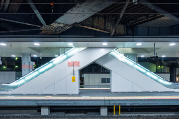 Modern illuminated double escalator on subway station in urban