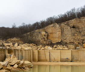A bustling limestone quarry, showcasing the process of extracting valuable stone blocks. The quarry...