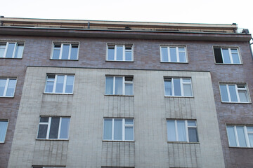 A detailed closeup view of an urban apartment building that showcases its unique and distinctive architectural style