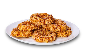 Crispy homemade rice crackers with cane sugar syrup in white ceramic plate isolated on white background with clipping path.