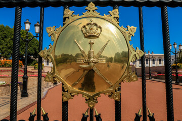 The emblem of the Sultan\'s Palace beautifully displayed at Muscat\'s entrance under clear blue...
