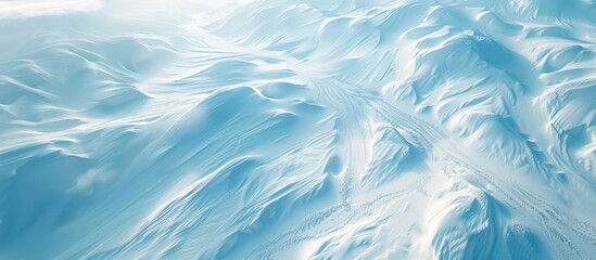 A scenic winter landscape with snow covered grounds showcasing intricate wind created patterns Top down perspective offering ample copy space image