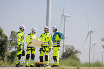 Engineers are having a discussion at wind turbine field © charnsitr