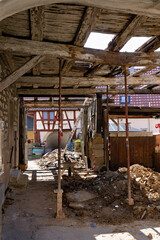 old, dilapidated half-timbered house, supported and in need of renovation