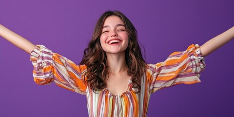 A woman stands with her arms spread wide, evoking a sense of freedom and joy