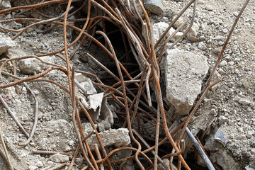 Fragments of rusty reinforcement sticking out on construction site