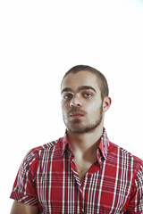 Obraz premium Young man with short hair and red shirt posing on white backgrou