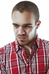 Young man with concerned expression looking down