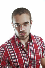 Serious young man wearing red shirt staring at camera