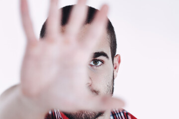 Young man making stop gesture with hand