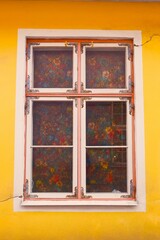 Flower windows of yellow house