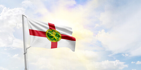 Alderney flag waving on sky background. 3D Rendering