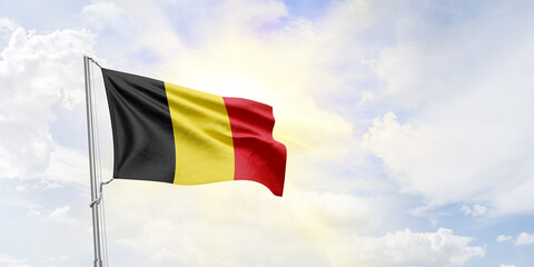 Belgium flag waving on sky background. 3D Rendering