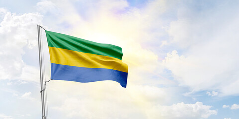 Gabon flag waving on sky background. 3D Rendering