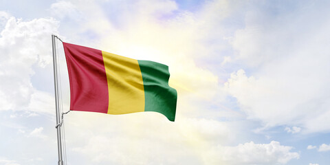 Guinea flag waving on sky background. 3D Rendering