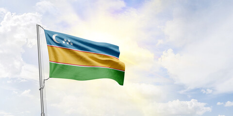 Karakalpakstan flag waving on sky background. 3D Rendering