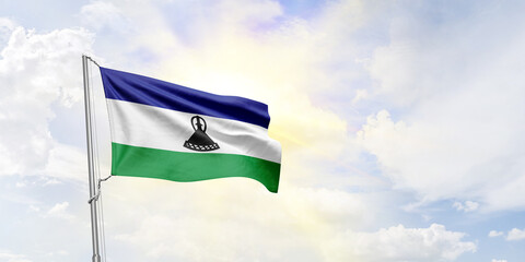 Lesotho flag waving on sky background. 3D Rendering