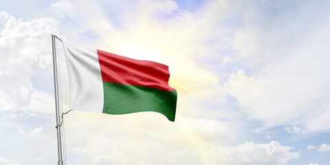 Madagascar flag waving on sky background. 3D Rendering