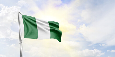 Nigeria flag waving on sky background. 3D Rendering