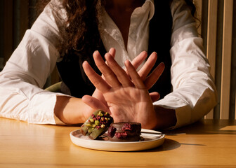 Counting calories and rejecting sugary treats. Choosing health over sweets.