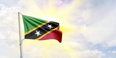 Saint Kitts and Nevis flag waving on sky background. 3D Rendering