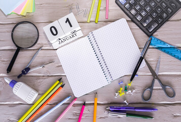January calendar with number. Copy of space note 1 . Top view of blank notepad. Space for text in a checkered sheet, stationery background with accessories.