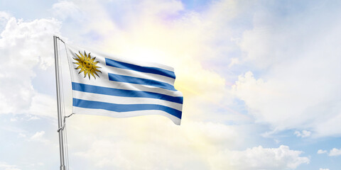 Uruguay flag waving on sky background. 3D Rendering