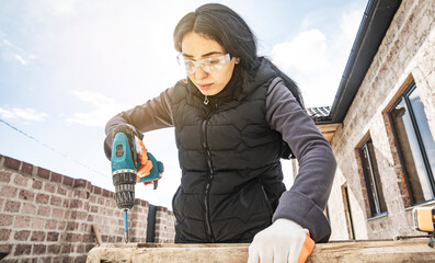 Carpenter working with equipment on wooden
