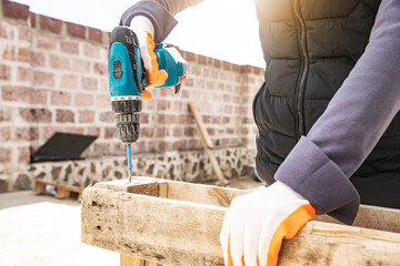 Carpenter working with equipment on wooden