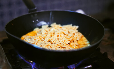 Preparing pasta carbonara in a restaurant.