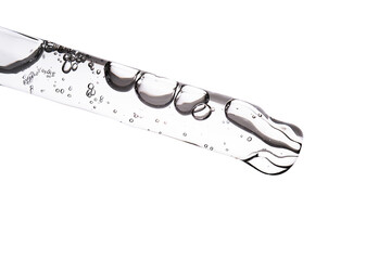 Dropper pipette with delicious serum with bubbles close-up.