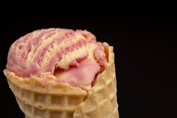waffle cone with ice cream and pieces of melon and watermelon