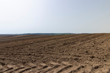 poor infertile soil in the field in the spring after plowing