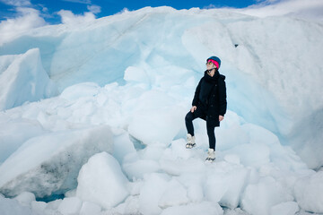 Woman is hiking on Matanuska Glacier near Glenn Highway in Alaska.