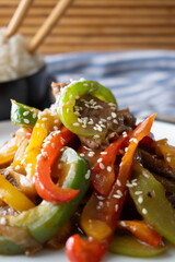Stir-Fried Beef and Bell Peppers with Rice, Asian Cuisine Dinner Plate with Chopsticks, Homemade Meal