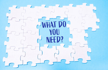 Puzzle pieces with What do you need text on a blue background