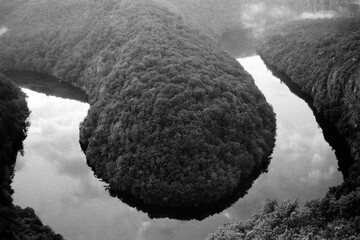 meander of Vltava river from Maj prospect in Czechia on 26. August 2024 on black and white film - blurriness and noise of scanned 35mm film were intentionally left in image