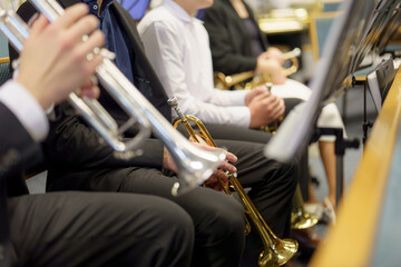 A male musician plays the trumpet in a folk brass band.