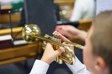 A male musician plays the trumpet in a folk brass band.