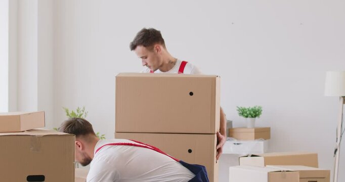 Dedicated team of movers from a relocation service is actively engaged in relocation to a new home or office. The staff is handling the moving process, ensuring items are delivered safely.