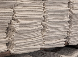 neatly folded household linens placed on a shelf