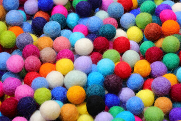 background ofwool balls ideal for creating necklaces by piercing them with a needle and other fashion accessories and for hobbying