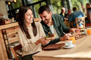 Enjoying a delightful brunch together at a cozy cafe on a sunny afternoon in the heart of the city