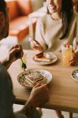 Enjoying dessert together in a cozy cafe while sharing laughter and delightful conversation on a...