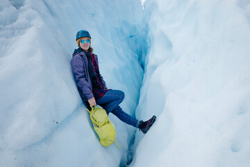Woman is hiking on Matanuska Glacier near Glenn Highway in Alaska.