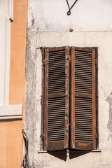 Old wooden weathered vintage window with shutters in Rome, Italy